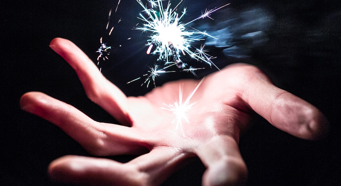 hand with magic sparkle above it
